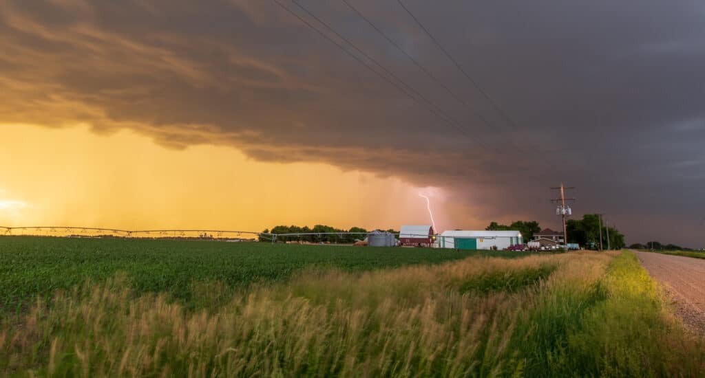 Lightning strikes behind a farmhouse in Central Nebraska June 13, 2017