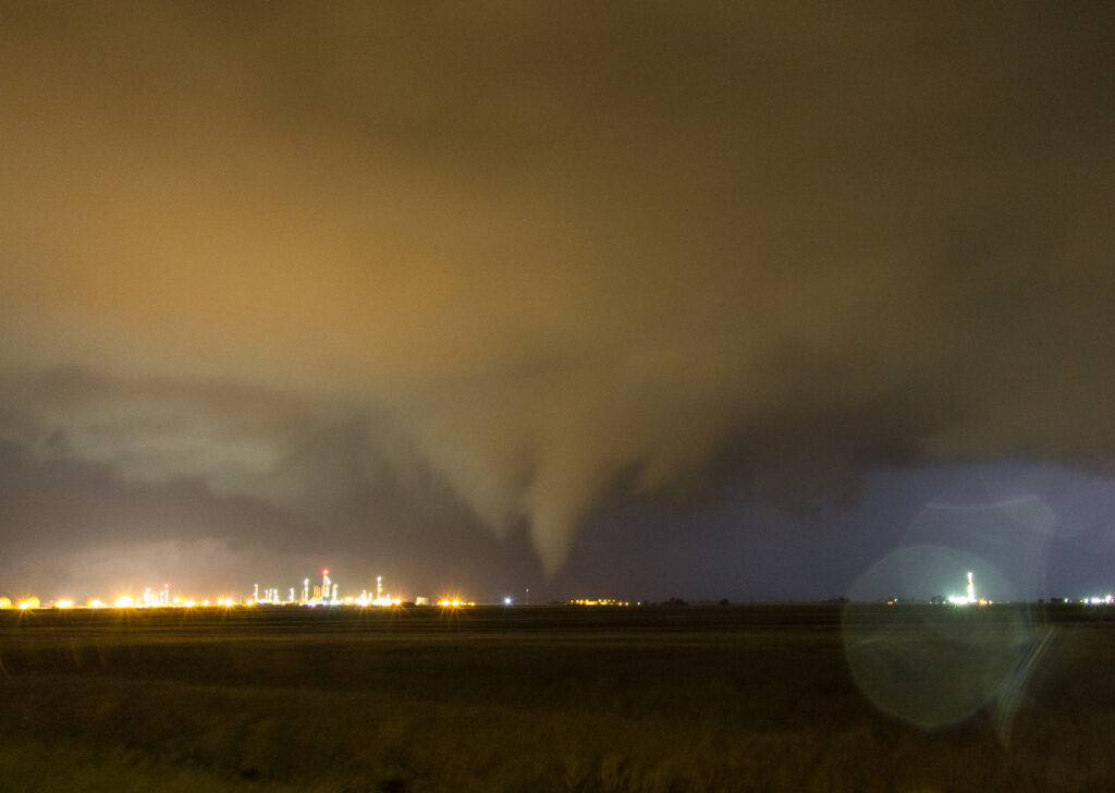 Tornado illuminated by Oil Refinery