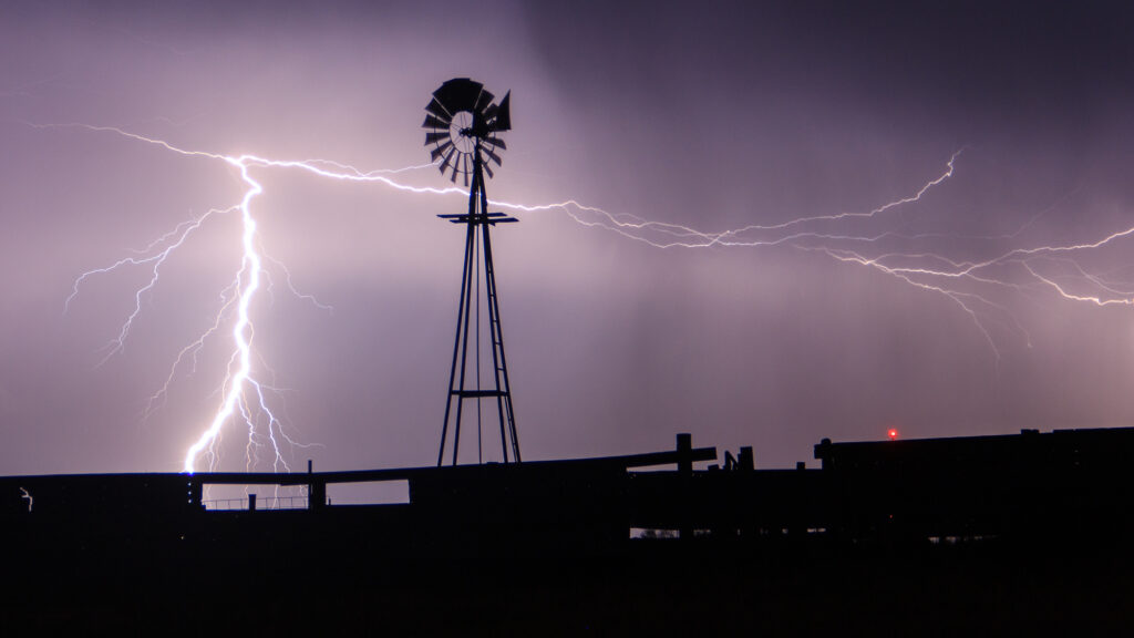 Lightning strikes behind a windmill in Western Oklahoma