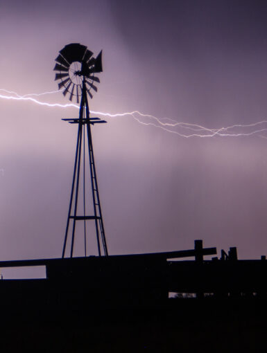 Lightning strikes behind a windmill in Western Oklahoma