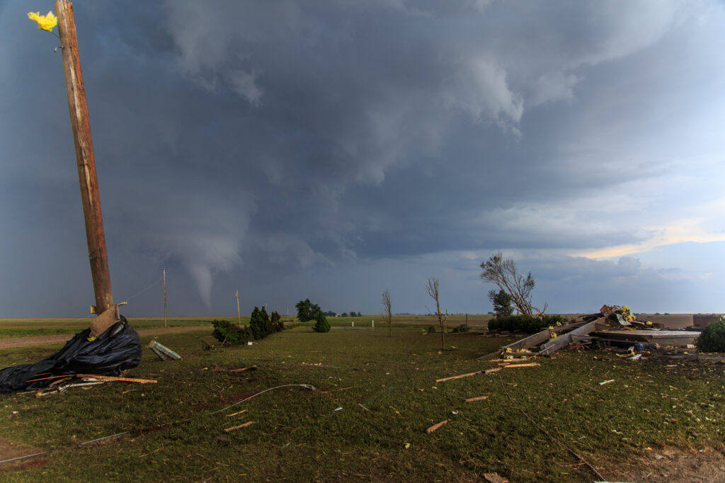 The Dodge City tornado continues behind the scene of this destroyed home